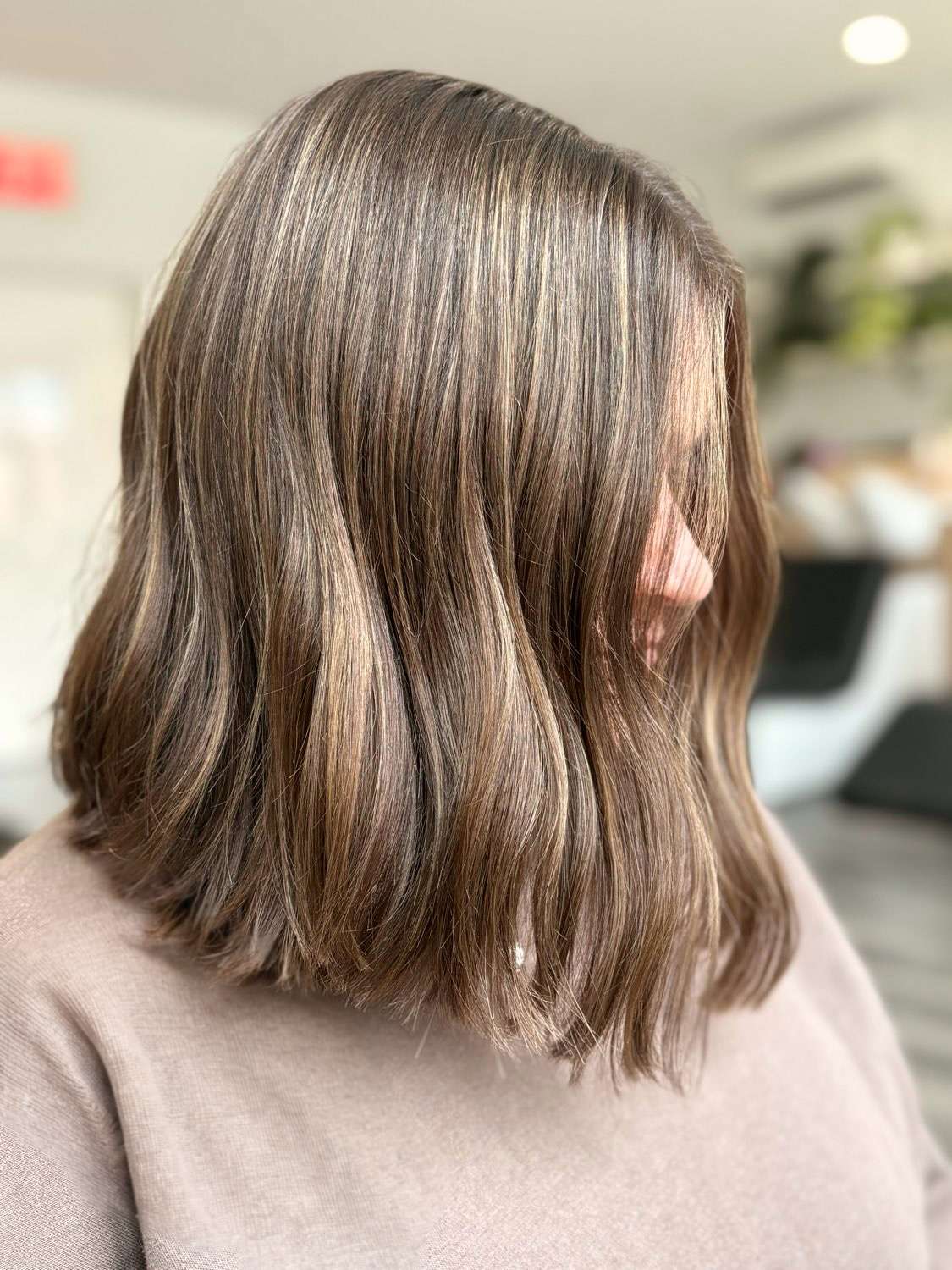 Blonde highlights on brunette hair done by Brooklyn colorist at The Bird House Hair Salon in Brooklyn, NY